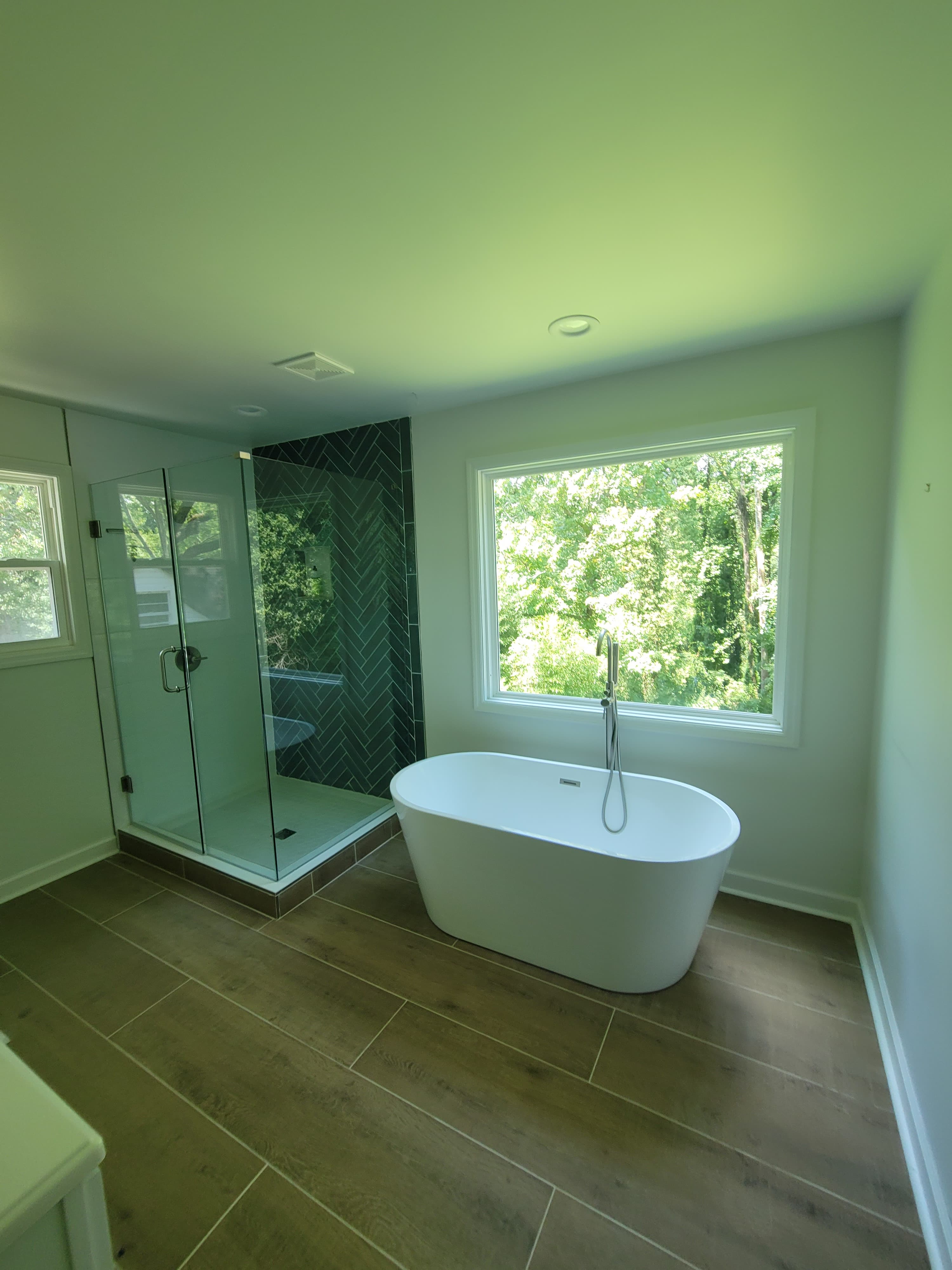 Bathroom with freestanding tub and glass shower enclosure
