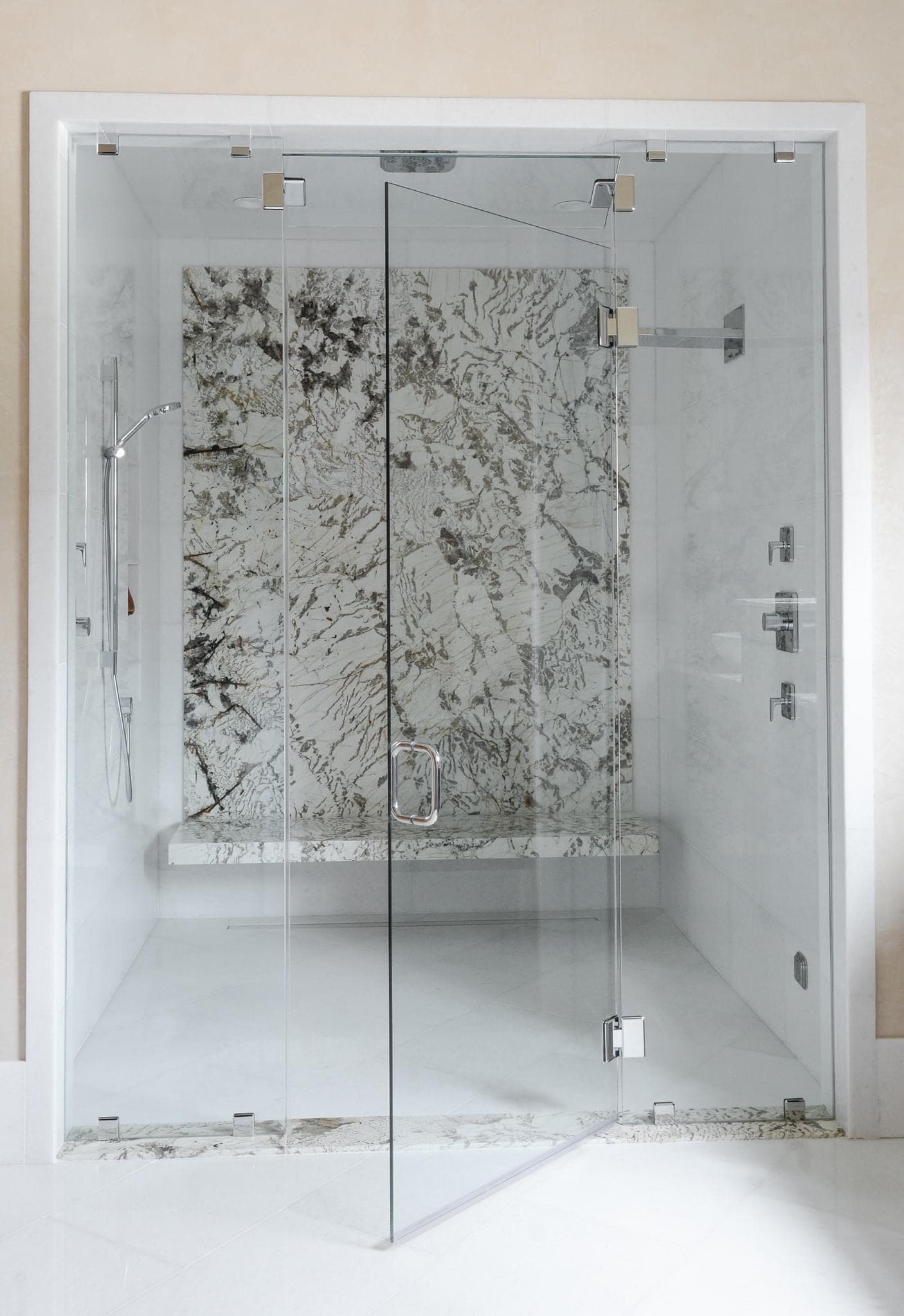 Luxurious shower with marble-pattern tile wall