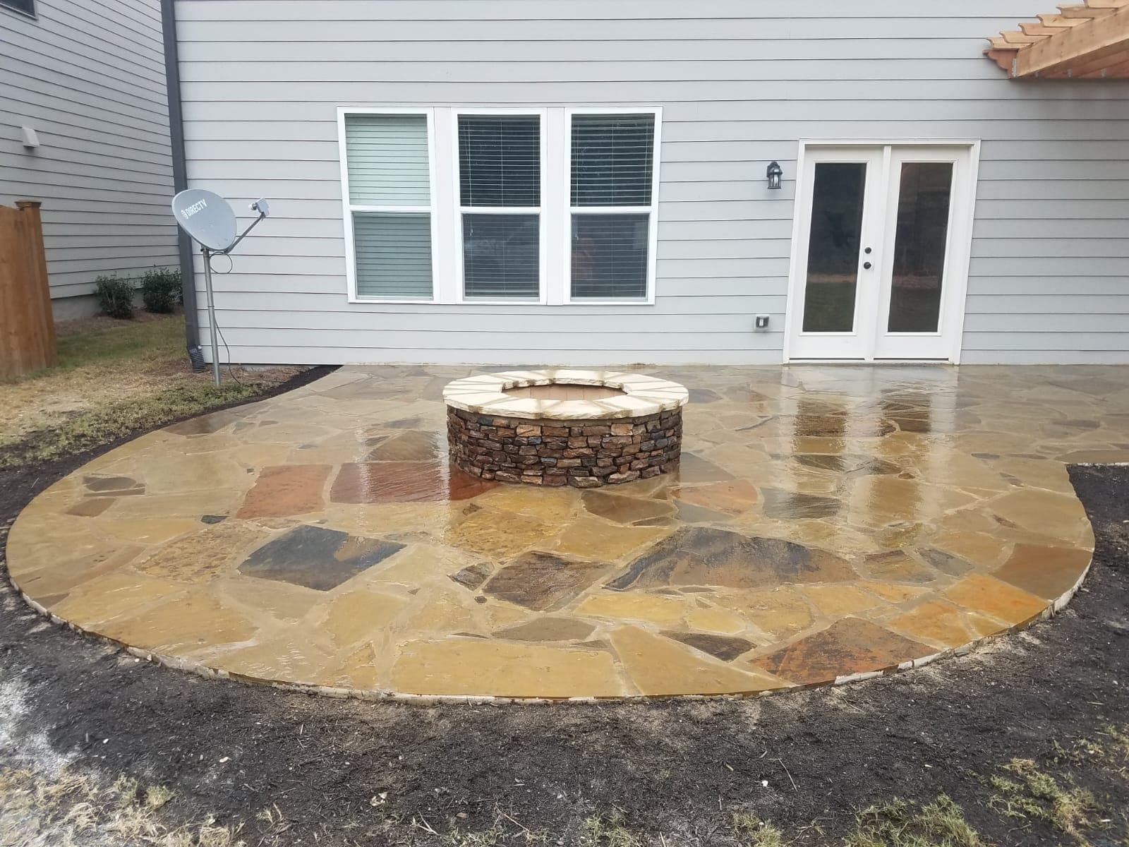 Fire pit with flagstone patio by the house