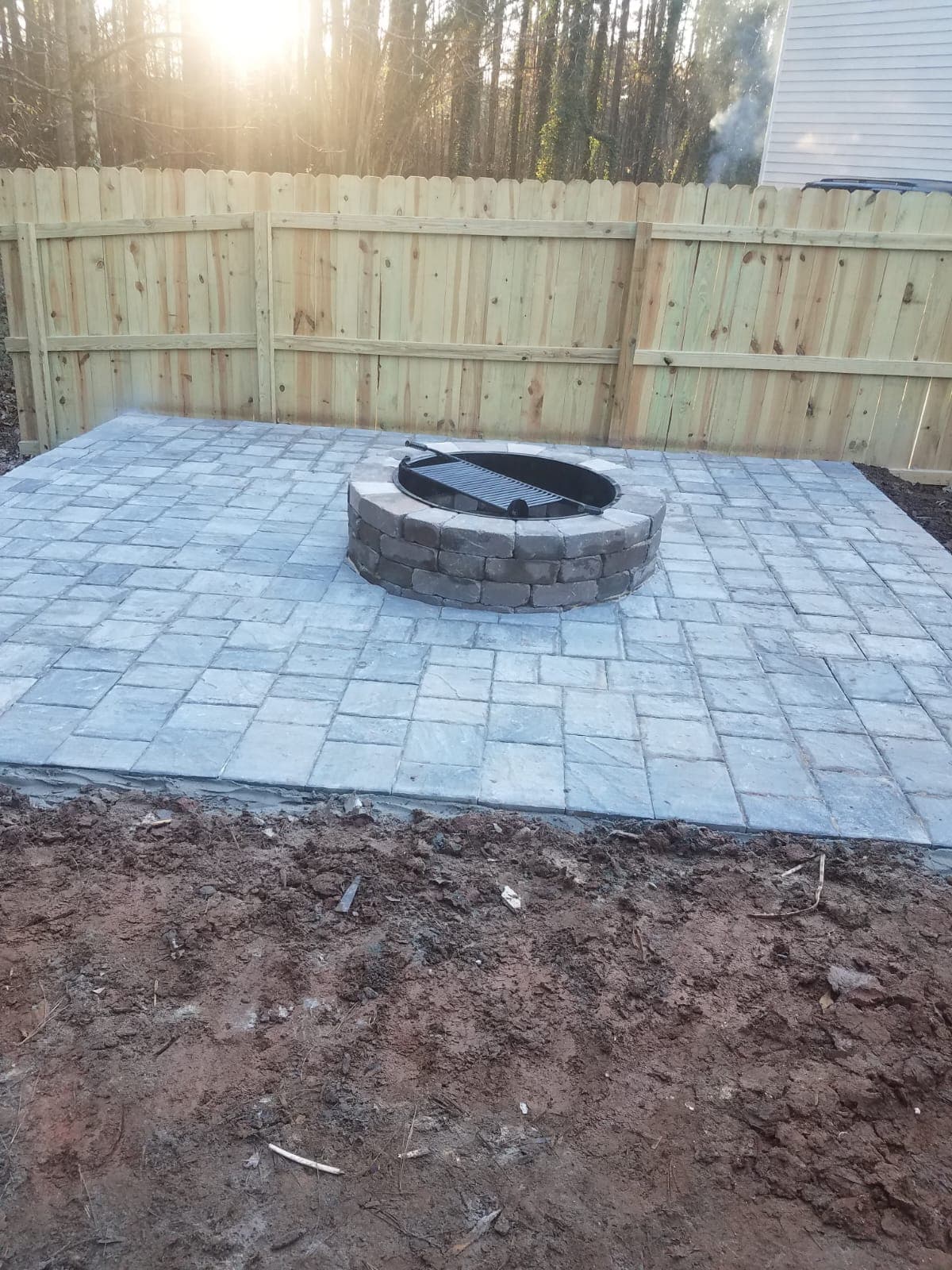 Square paver patio with block fire pit and grill insert
