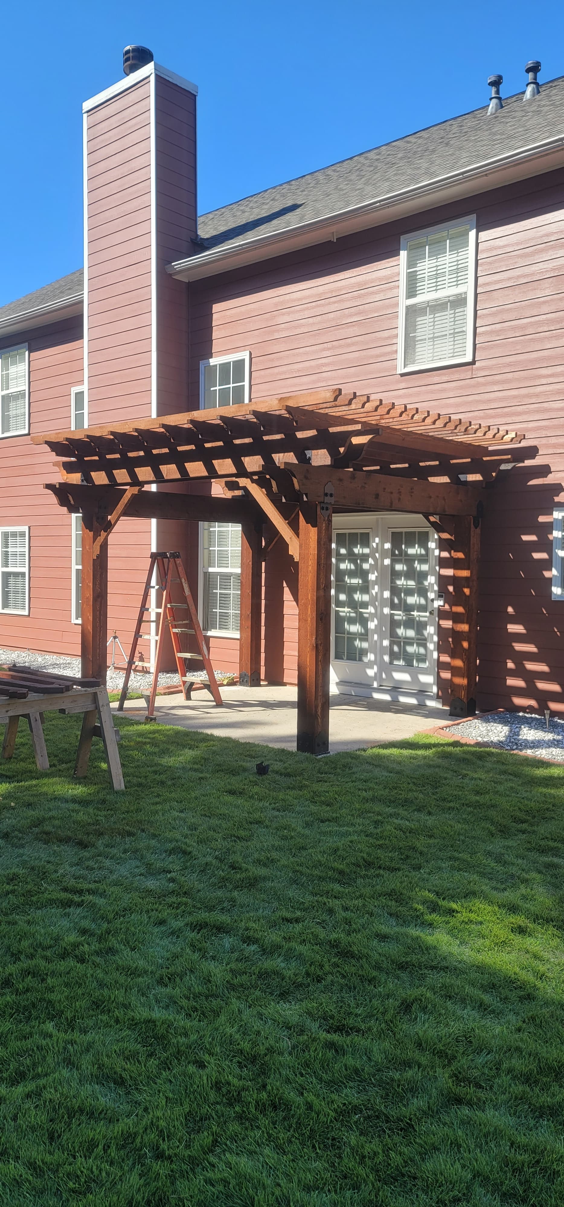 Custom wooden pergola over backyard patio