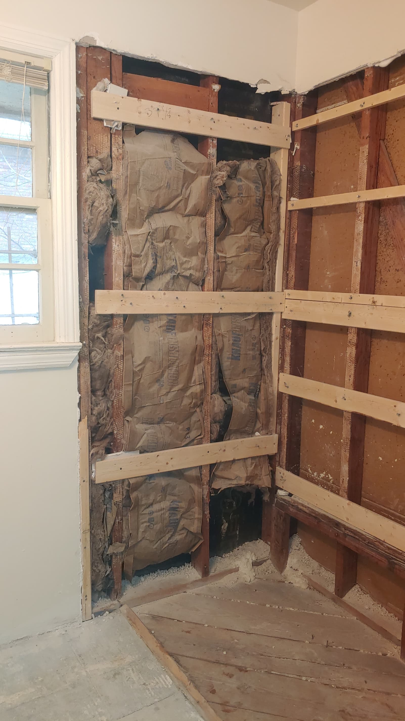 Bathroom before remodel with walls opened to studs