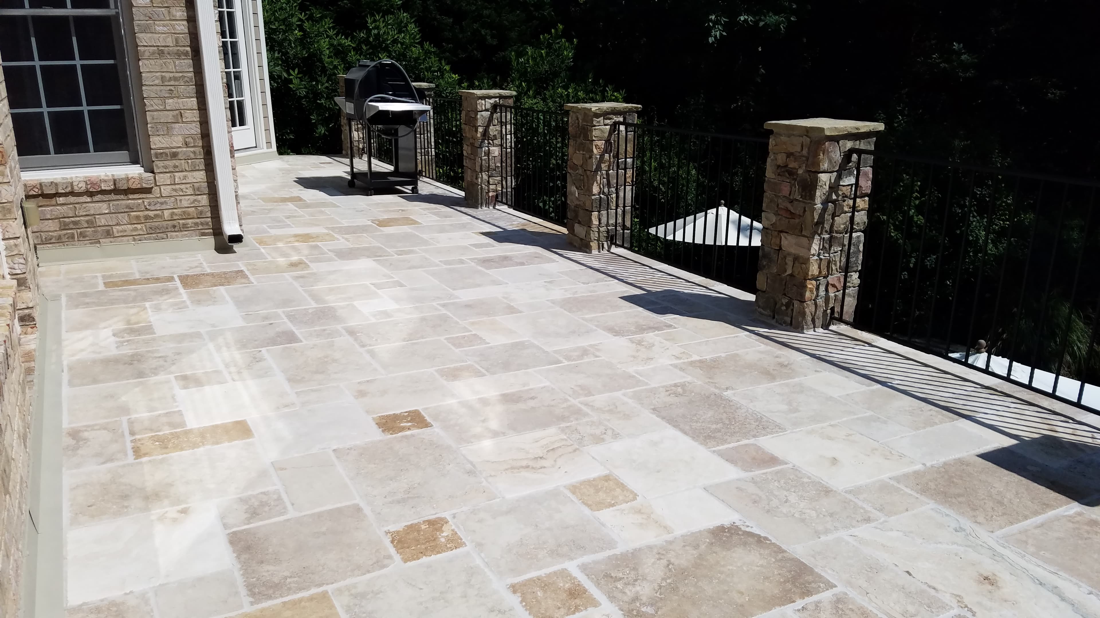 Stone tile poolside patio