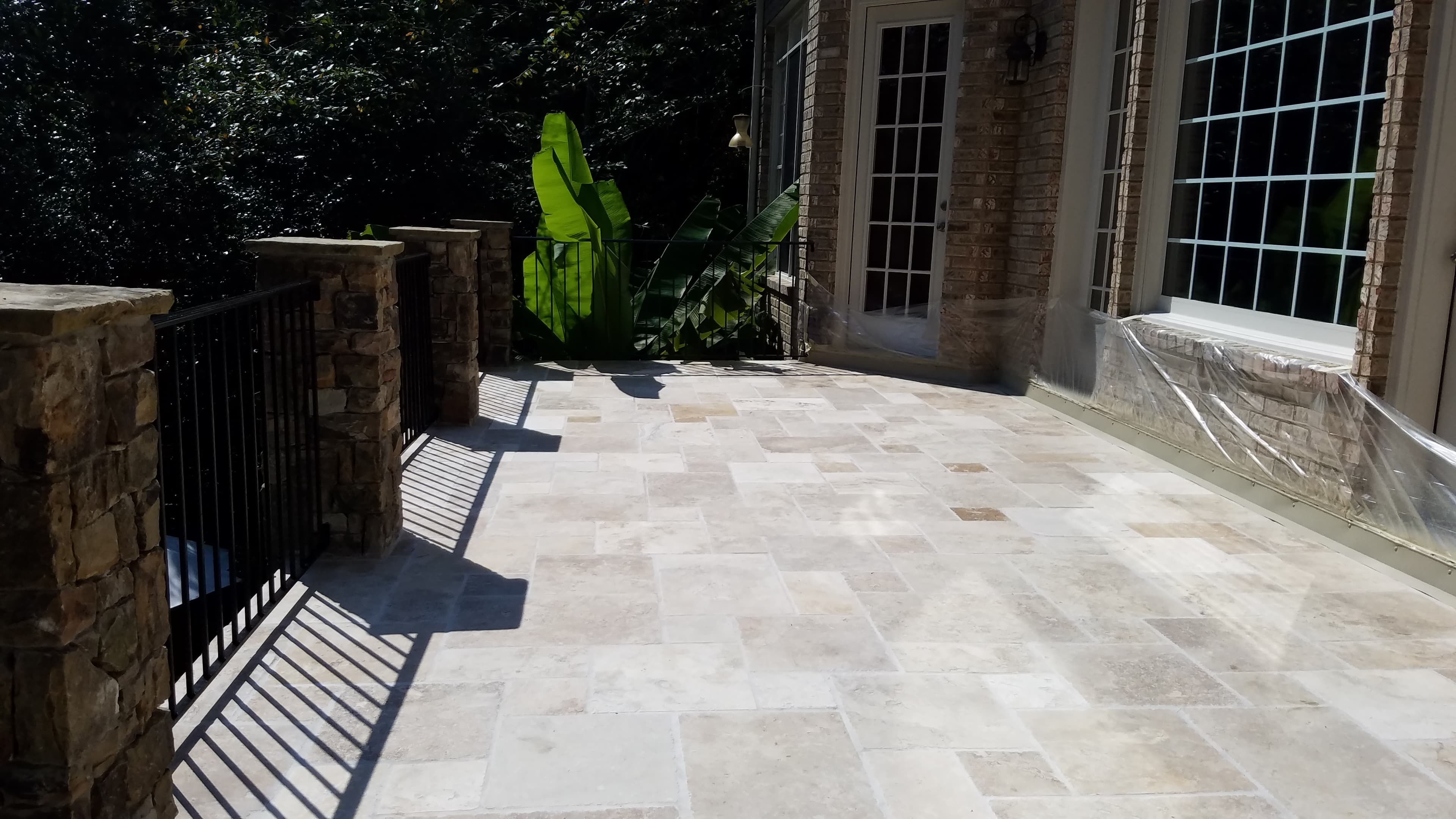 View of tiled patio with stone railing posts